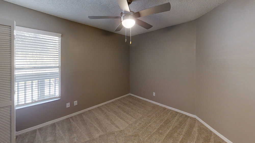 bedroom with carpet, window and ceiling fan