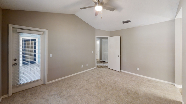 renovated living room with ceiling fan and leading to patio